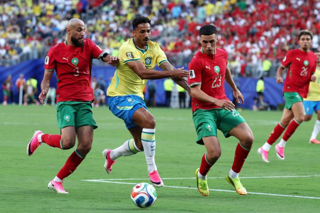 (L-R) Morocco's defender #03 Noussair Mazraoui, Brazil's defender #13 Danilo, and Morocco's midfielder #23 Bilal El Khannouss fight for the ball during the 2026 World Cup Group C football match between Brazil and Morocco at the New York/New Jersey Stadium in East Rutherford on June 13, 2026. (Photo by TIMOTHY A. CLARY / AFP)