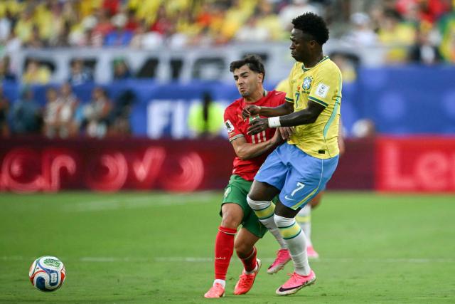 Morocco's forward #10 Brahim Diaz and Brazil's forward #07 Vinicius Junior fight for the ball during the 2026 World Cup Group C football match between Brazil and Morocco at the New York/New Jersey Stadium in East Rutherford on June 13, 2026. (Photo by MAURO PIMENTEL / AFP)