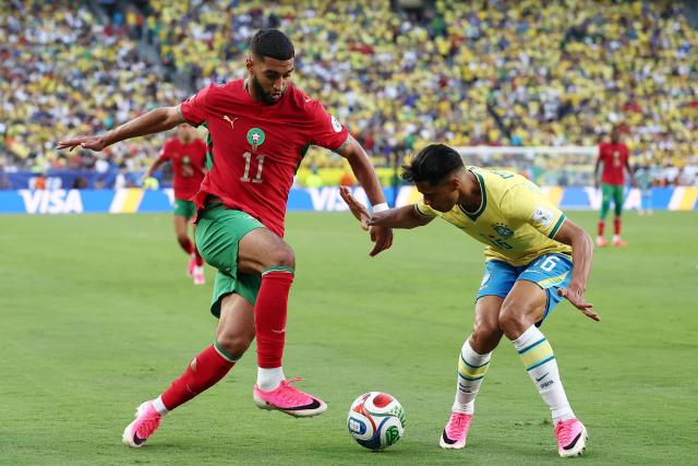 Morocco's midfielder #11 Ismael Saibari and Brazil's defender #16 Douglas Santos fight for the ball during the 2026 World Cup Group C football match between Brazil and Morocco at the New York/New Jersey Stadium in East Rutherford on June 13, 2026. (Photo by CHARLY TRIBALLEAU / AFP)