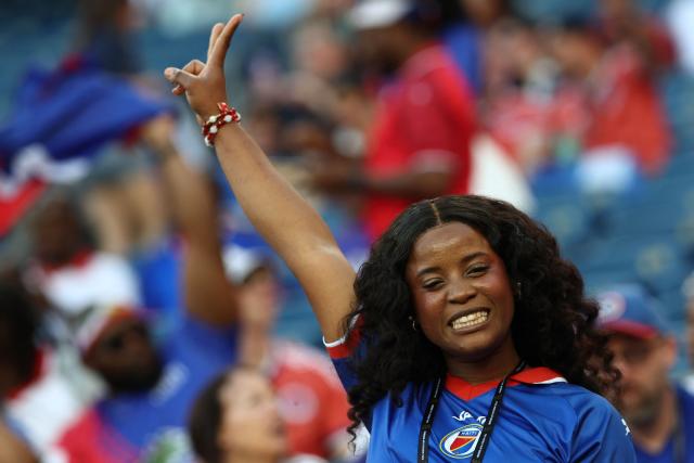 A Haiti fan poses for pictures ahead of the 2026 World Cup Group C football match between Haiti and Scotland at the Boston Stadium in Foxborough on June 13, 2026. (Photo by FRANCK FIFE / AFP)