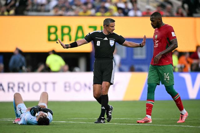 Slovene referee Slavko Vincic gestures next to Morocco's goalkeeper #01 Yassine Bounou (L) and defender #14 Issa Diop during the 2026 World Cup Group C football match between Brazil and Morocco at the New York/New Jersey Stadium in East Rutherford on June 13, 2026. (Photo by Mauro PIMENTEL / AFP)