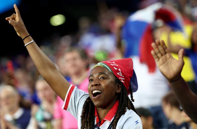 A Haiti fan cheers ahead of the 2026 World Cup Group C football match between Haiti and Scotland at the Boston Stadium in Foxborough on June 13, 2026. (Photo by FRANCK FIFE / AFP)