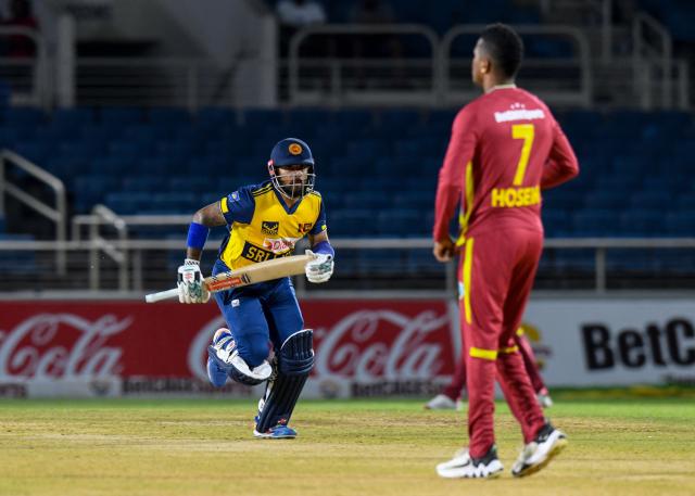 Kusal Mendis (L) of Sri Lanka get runs off Akeal Hosein (R) of West Indies during the second Twenty20 (T20) international cricket match between West Indies and Sri Lanka at Sabina Park in Kingston, Jamaica, on June 13, 2026. (Photo by Randy Brooks / AFP)