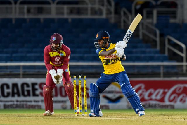 Pathum Nissanka (R) of Sri Lanka hits 4 and Shai Hope (L) of West Indies watches during the second Twenty20 (T20) international cricket match between West Indies and Sri Lanka at Sabina Park in Kingston, Jamaica, on June 13, 2026. (Photo by Randy Brooks / AFP)