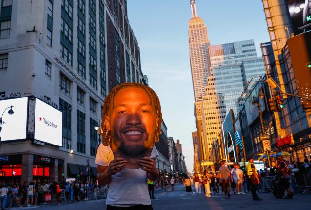 A Knicks fan holds a giant cutout of Knicks guard Jalen Brunson outside Madison Square Garden before Game 5 of the NBA finals between the New York Knicks and San Antonio Spurs, in New York, on June 13, 2026. (Photo by kena betancur / AFP)