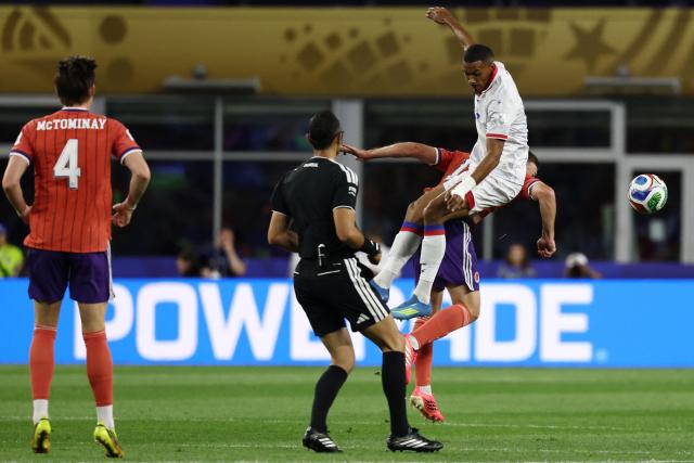 Haiti's forward #18 Wilson Isidor (top) and Scotland's midfielder #19 Lewis Ferguson fight for the ball during the 2026 World Cup Group C football match between Haiti and Scotland at the Boston Stadium in Foxborough on June 13, 2026. (Photo by FRANCK FIFE / AFP)