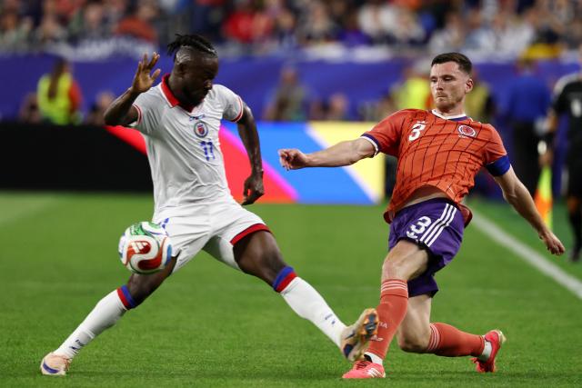 Haiti's forward #11 Louicius Deedson and Scotland's defender #03 Andrew Robertson fight for the ball during the 2026 World Cup Group C football match between Haiti and Scotland at the Boston Stadium in Foxborough on June 13, 2026. (Photo by FRANCK FIFE / AFP)