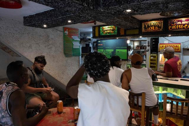 Cubans watch the FIFA World Cup match between Brazil and Morocco on a TV at a bar in the Centro Habana neighborhood, in Havana, on June 13, 2026. (Photo by Pablo PORCIUNCULA / AFP)