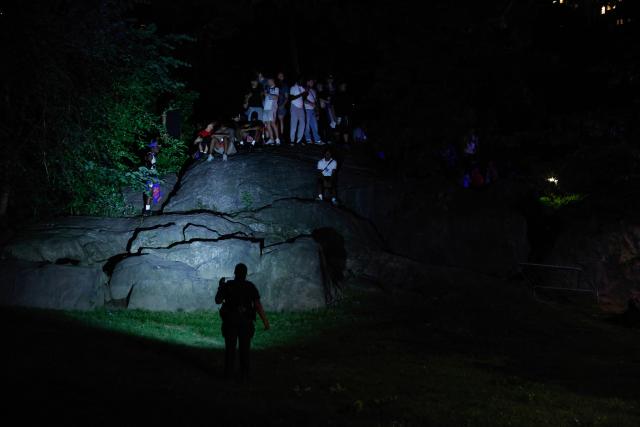 A police officer prevents Knicks fans from entering Wollman Rink in Central Park to watch Game 5 of the NBA finals between the New York Knicks and San Antonio Spurs, in New York, on June 13, 2026. (Photo by kena betancur / AFP)