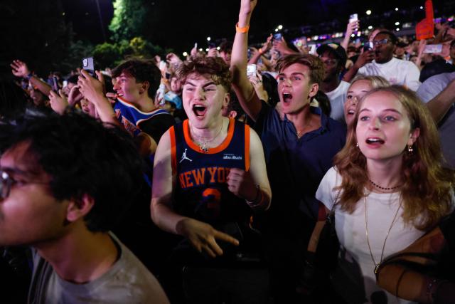Knicks fans celebrate in Central Park after the New York Knicks defeated the San Antonio Spurs in Game 5 of the NBA Finals to win the series, in New York, on June 13, 2026. The Knicks won the NBA Championship for the first time since 1973, for the third time in franchise history. (Photo by kena betancur / AFP)