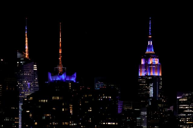 The Empire State Building is lit with the colors of New York Knicks after the New York Knicks defeated the San Antonio Spurs in Game 5 of the NBA Finals to win the series, as seen from West New York, New Jersey, on June 13, 2026. The Knicks won the NBA Championship for the first time since 1973, for the third time in franchise history. (Photo by Leonardo MUNOZ / AFP)