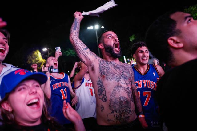 Knicks fans celebrate in Central Park after the New York Knicks defeated the San Antonio Spurs in Game 5 of the NBA Finals to win the series, in New York, on June 13, 2026. The Knicks won the NBA Championship for the first time since 1973, for the third time in franchise history. (Photo by kena betancur / AFP)
