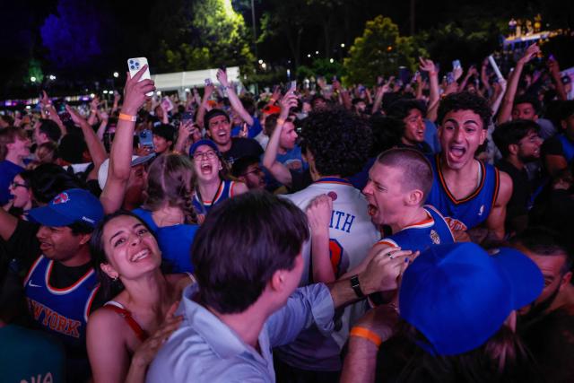 Knicks fans celebrate in Central Park after the New York Knicks defeated the San Antonio Spurs in Game 5 of the NBA Finals to win the series, in New York, on June 13, 2026. The Knicks won the NBA Championship for the first time since 1973, for the third time in franchise history. (Photo by kena betancur / AFP)