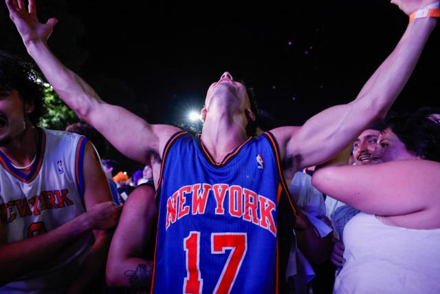 Knicks fans celebrate in Central Park after the New York Knicks defeated the San Antonio Spurs in Game 5 of the NBA Finals to win the series, in New York, on June 13, 2026. The Knicks won the NBA Championship for the first time since 1973, for the third time in franchise history. (Photo by kena betancur / AFP)