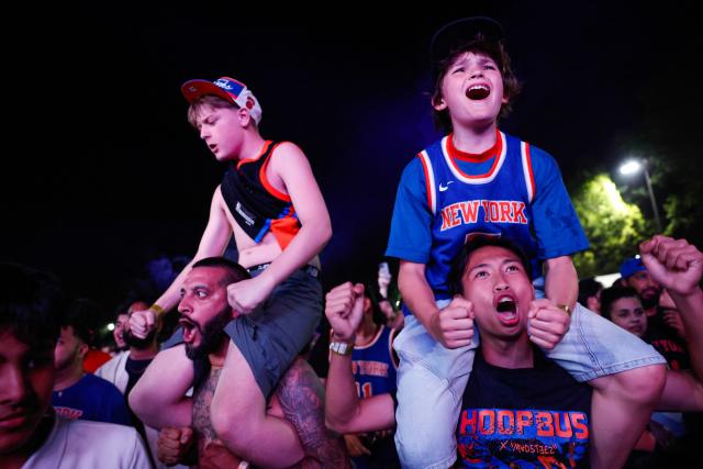 Knicks fans celebrate in Central Park after the New York Knicks defeated the San Antonio Spurs in Game 5 of the NBA Finals to win the series, in New York, on June 13, 2026. The Knicks won the NBA Championship for the first time since 1973, for the third time in franchise history. (Photo by kena betancur / AFP)