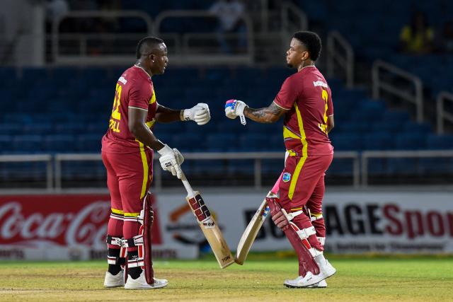 Rovman Powell (L) and Shimron Hetmyer (r) of West Indies bump fists after 50 runs partnership during the second Twenty20 (T20) international cricket match between West Indies and Sri Lanka at Sabina Park in Kingston, Jamaica, on June 13, 2026. (Photo by Randy Brooks / AFP)