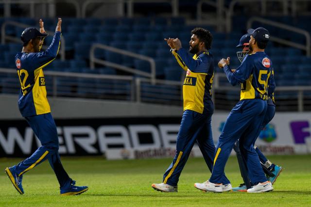 Dunith Wellalage (2R) of Sri Lanka celebrates the dismissal of Romario Shepherd of West Indies during the second Twenty20 (T20) international cricket match between West Indies and Sri Lanka at Sabina Park in Kingston, Jamaica, on June 13, 2026. (Photo by Randy Brooks / AFP)