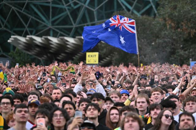 Football fans watch a broadcast of the FIFA World Cup 2026 Group D match between Australia and Turkey on a giant screen during a public viewing event at Federation Square in Melbourne on June 14, 2026. (Photo by WILLIAM WEST / AFP)