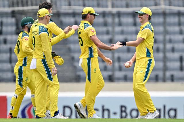 Australia's Riley Meredith (R) celebrates with teammates after taking a catch to dismiss Bangladesh's Tanzid Hasan during the third one-day international (ODI) cricket match between Bangladesh and Australia at the Sher-e-Bangla National Stadium in Dhaka on June 14, 2026. (Photo by Munir UZ ZAMAN / AFP)