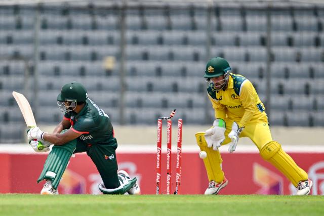 Bangladesh's captain Najmul Hossain Shanto (L) is clean bowled by Australia's Matt Renshaw as wicketkeeper and captain Josh Inglis gestures during the third one-day international (ODI) cricket match between Bangladesh and Australia at the Sher-e-Bangla National Stadium in Dhaka on June 14, 2026. (Photo by Munir UZ ZAMAN / AFP)