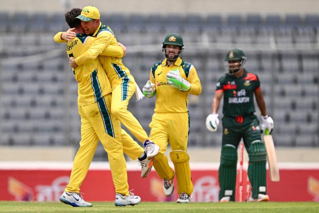 Australia's Matt Renshaw (L) celebrates with teammates after taking the wicket of Bangladesh's captain Najmul Hossain Shanto (R) during the third one-day international (ODI) cricket match between Bangladesh and Australia at the Sher-e-Bangla National Stadium in Dhaka on June 14, 2026. (Photo by Munir UZ ZAMAN / AFP)