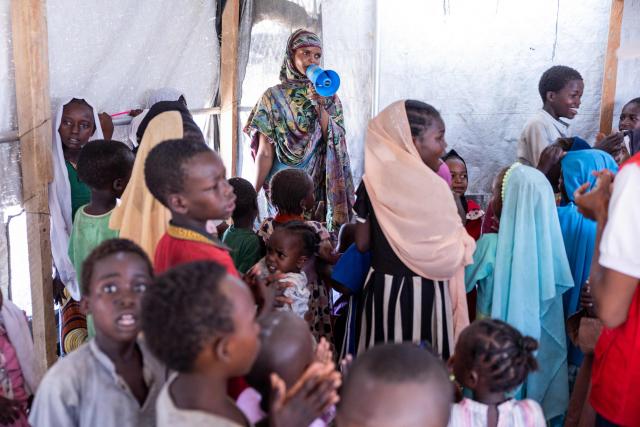 Chadian students sing in the Tongori camp for Chadian returnees on June 9, 2026. Rising numbers of Chadians fleeing the Sudan war are arriving at the Adre border post in Chad, but funding shortages could force UN agencies on the ground to stop operating.
The civil conflict in Sudan has already cost tends of thousands of lives and forced more than 12 million people to flee their homes, more a million of them Chadian, according to UN figures. (Photo by Joris Bolomey / AFP)