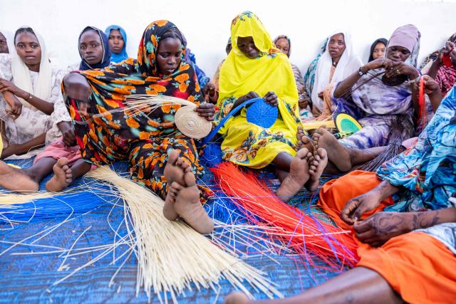 Chadian women weave plastic threads in Tongori camp for Chadian returnees, on June 9, 2026. Rising numbers of Chadians fleeing the Sudan war are arriving at the Adre border post in Chad, but funding shortages could force UN agencies on the ground to stop operating.
The civil conflict in Sudan has already cost tends of thousands of lives and forced more than 12 million people to flee their homes, more a million of them Chadian, according to UN figures. (Photo by Joris Bolomey / AFP)