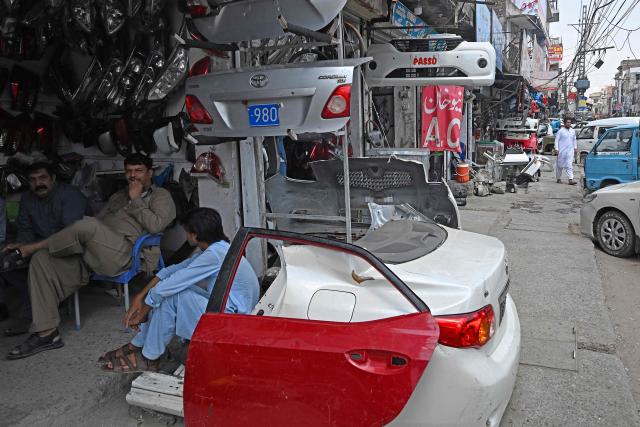 Shopkeepers selling auto parts wait for customers at the Sultan Khoo market in Rawalpindi on June 14, 2026. Pakistan's government presented its annual budget on June 12, including plans to boost tax collection and defence spending, as citizens expressed weariness with surging inflation sparked by the Middle East crisis that Islamabad is mediating to end. (Photo by Aamir QURESHI / AFP)