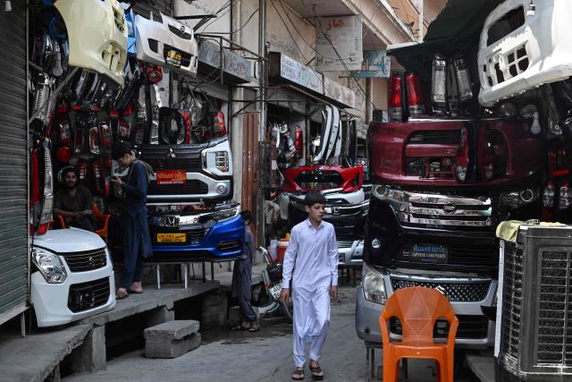 Shopkeepers selling auto parts wait for customers at the Sultan Khoo market in Rawalpindi on June 14, 2026. Pakistan's government presented its annual budget on June 12, including plans to boost tax collection and defence spending, as citizens expressed weariness with surging inflation sparked by the Middle East crisis that Islamabad is mediating to end. (Photo by Aamir QURESHI / AFP)