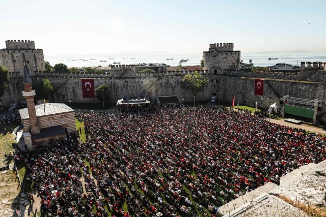 Turkish fans watch a broadcast of the FIFA World Cup 2026 Group D match between Australia and Turkey on a giant screen at the Yedikule fortress, which encloses a section of the ancient Walls of Constantinople, in Istanbul on June 14, 2026. (Photo by BERK OZKAN / AFP)