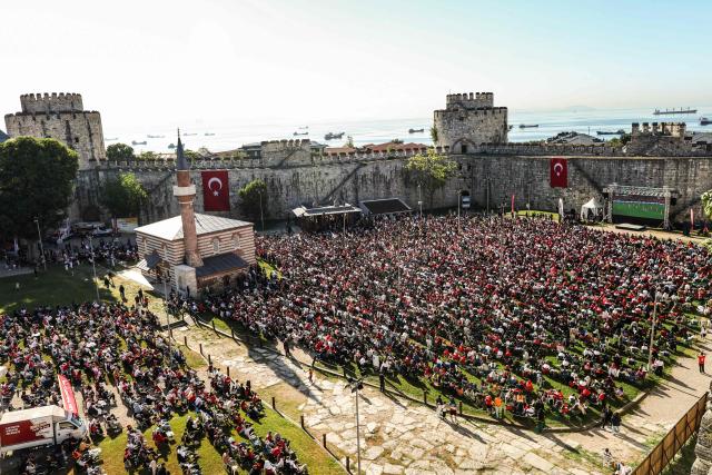 Turkish fans watch a broadcast of the FIFA World Cup 2026 Group D match between Australia and Turkey on a giant screen at the Yedikule fortress, which encloses a section of the ancient Walls of Constantinople, in Istanbul on June 14, 2026. (Photo by BERK OZKAN / AFP)