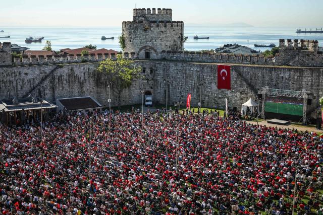 Turkish fans watch a broadcast of the FIFA World Cup 2026 Group D match between Australia and Turkey on a giant screen at the Yedikule fortress, which encloses a section of the ancient Walls of Constantinople, in Istanbul on June 14, 2026. (Photo by BERK OZKAN / AFP)