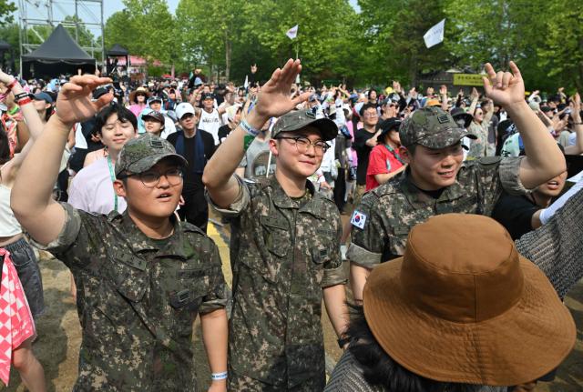 South Korean soldiers gesture during a performance by French rock band "La Femme" at the DMZ Peace Train Festival in Cheorwon near the North Korean border on June 14, 2026. (Photo by Jung Yeon-je / AFP)