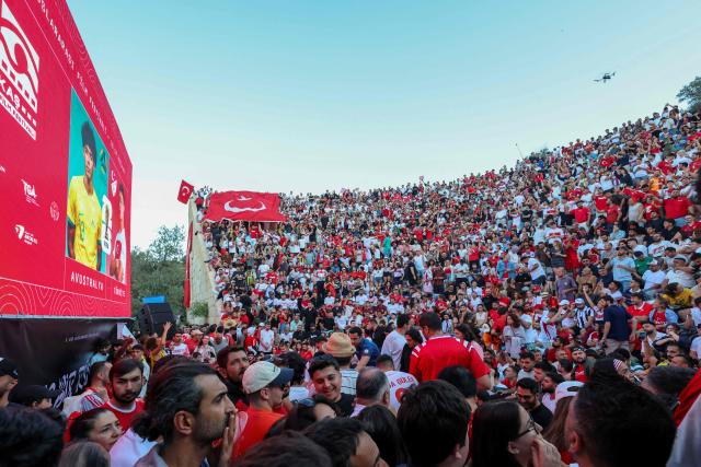Turkish fans watch a broadcast of the FIFA World Cup 2026 Group D match between Australia and Turkey at the Hellenistic amphitheatre of Antiphellos at Kas district of Antalya on June 14, 2026. (Photo by ONER SAN / AFP)