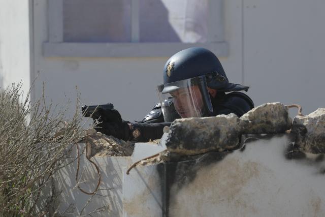A gendarme aims with a handgun during a dynamic demonstration of military equipment at the Eurosatory trade show, dedicated to defense and security, at the Paris Nord Villepinte Exhibition Center in Villepinte, northeastern suburb of Paris on June 14, 2026. The Eurosatory trade show takes place from June 15 to 19, 2026. (Photo by Kenzo TRIBOUILLARD / AFP)
