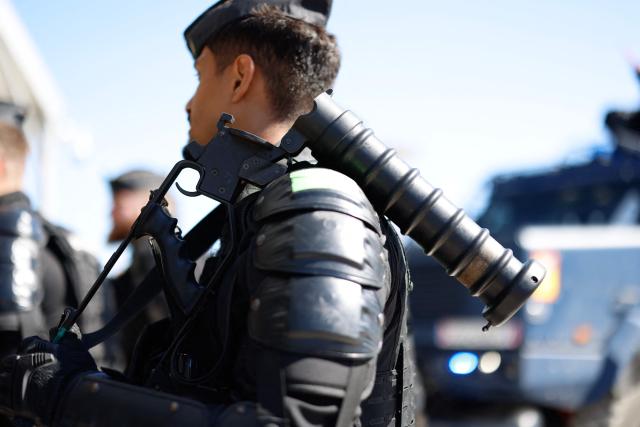 A gendarme stand with the 56 mm Cougar grenade launcher during a dynamic demonstration of military equipment at the Eurosatory trade show, dedicated to defense and security, at the Paris Nord Villepinte Exhibition Center in Villepinte, northeastern suburb of Paris on June 14, 2026. The Eurosatory trade show takes place from June 15 to 19, 2026. (Photo by Kenzo TRIBOUILLARD / AFP)