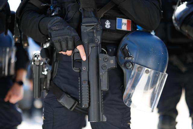 A gendarme holds a less-lethal launcher (LBD) during a dynamic demonstration of military equipment at the Eurosatory defence and security trade show at the Paris Nord Villepinte Exhibition Centre in Villepinte, a northeastern suburb of Paris, on June 14, 2026. The Eurosatory trade show takes place from June 15 to 19, 2026. (Photo by Kenzo TRIBOUILLARD / AFP)