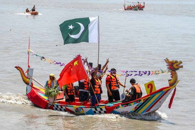 Pakistanis participate in the Chinese Dragon Boat Festival, organised under cultural exchange between two countries, in Pakistan's Charsadda on June 14, 2026. (Photo by Abdul MAJEED / AFP)