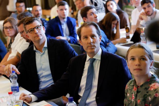 Members of the Swiss People's Party (SVP) react following first results of a vote on a divisive anti-immigration proposal to cap the country's population and another referendum on restricting access to conscientious objection to military service, in Aarberg on June 14, 2026. The Swiss appeared on June 14, 2026 to have voted down a divisive anti-immigration proposal to cap the country's population, according to initial projections from the gfs.bern institute minutes after polling stations closed. A separate vote on a law restricting access to conscientious objection to military service meanwhile appeared set to pass, the projections showed. (Photo by STEFAN WERMUTH / AFP)