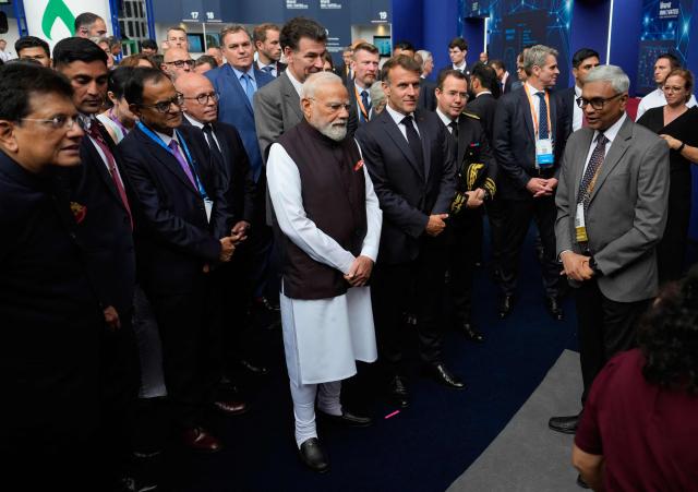 India's Prime Minister Narendra Modi and France's President Emmanuel Macron talks with attendees during the "Bharat Innovate 2026" event in Nice south-eastern France on June 14, 2026. (Photo by Lewis JOLY / POOL / AFP)