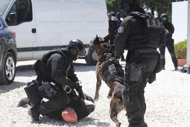 French policemen of the Search and Intervention Brigade (BRI) participate during a dynamic demonstration of military equipment at the Eurosatory trade show, dedicated to defense and security, at the Paris Nord Villepinte Exhibition Center in Villepinte, northeastern suburb of Paris on June 14, 2026. The Eurosatory trade show takes place from June 15 to 19, 2026. (Photo by Kenzo TRIBOUILLARD / AFP)