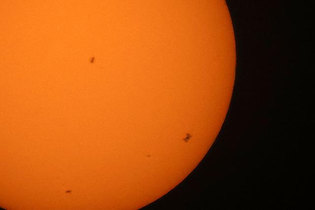 The International Space Station (ISS), (Bottom R) transits the sun as seen from Shuwaikh industrial  district in Kuwait City on June 14, 2026. (Photo by YASSER AL-ZAYYAT / AFP)