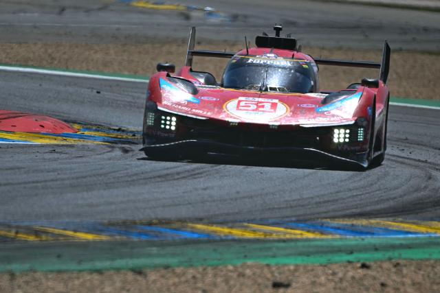 The Ferrari AF Corse's car of Italian driver Alessandro Pier Guidi, British driver James Calado and Italian driver Antonio Giovinazzi takes a corner during the 94th edition of the 24 Hours of Le Mans at the Le Mans circuit, north-western France, on June 14, 2026. (Photo by Lou BENOIST / AFP)