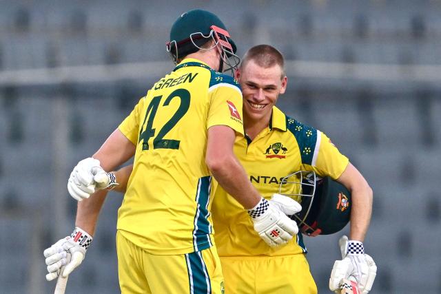 Australia's Cooper Connolly (R) celebrates with teammate Cameron Green after scoring a century (100 runs) during the third one-day international (ODI) cricket match between Bangladesh and Australia at the Sher-e-Bangla National Stadium in Dhaka on June 14, 2026. (Photo by Munir UZ ZAMAN / AFP)