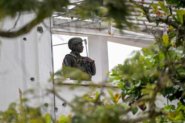 A police officer stands guard inside the damaged City Hall next to the Buenos Aires police station, months after it was heavily attacked, in Buenos Aires, Cauca department, Colombia, on June 13, 2026. Colombia will hold the runoff presidential election on June 21. (Photo by JOAQUIN SARMIENTO / AFP)