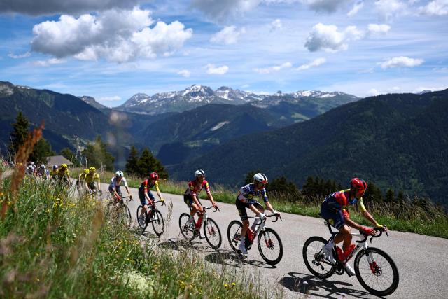 Lidl-Trek's Spanish rider Carlos Verona (R) and Lidl-Trek's US rider Quinn Simmons (2nd R)  cycle during the 8th and final stage of the Tour Auvergne-Rhone-Alpes cycling race (formerly known as the Criterium du Dauphine), 120,1km between Beaufort and Plateau de Solaison, in the French Alps on June 14, 2026. (Photo by Anne-Christine POUJOULAT / AFP)