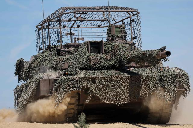 This photograph shows a AMX Leclerc (Char Leclerc) battle tank with an anti-drone cage on its top during a dynamic demonstration of military equipment at the Eurosatory trade show, dedicated to defense and security, at the Paris Nord Villepinte Exhibition Center in Villepinte, northeastern suburb of Paris on June 14, 2026. The Eurosatory trade show takes place from June 15 to 19, 2026. (Photo by Kenzo TRIBOUILLARD / AFP)