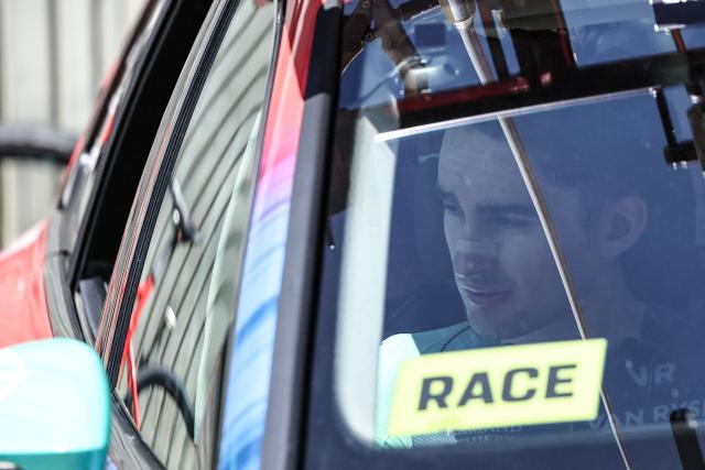Decathlon CMA CGM Team's French rider Paul Seixas sits in his team vehicle as he withdraws from the race on the 8th and final stage of the Tour Auvergne-Rhone-Alpes cycling race (formerly known as the Criterium du Dauphine), 120,1km between Beaufort and Plateau de Solaison, in the French Alps on June 14, 2026. (Photo by Anne-Christine POUJOULAT / AFP)