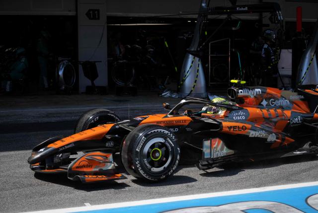 Technician work on McLaren British driver Lando Norris's car exits the pit stop during the Catalonia Formula One Grand Prix at the Circuit de Catalunya in Montmelo, on the outskirts of Barcelona, on June 14, 2026. (Photo by Manaure QUINTERO / POOL / AFP)