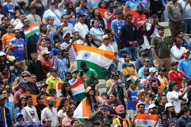India supporters cheer at the start of the ICC Women's T20 cricket World Cup 2026 Group A stage, Match 6 match between the India and Pakistan at Edgbaston cricket ground in Birmingham, central England on June 14, 2026. (Photo by Darren Staples / AFP)
